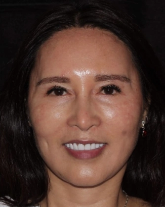 Woman dark hair smiling teeth visible