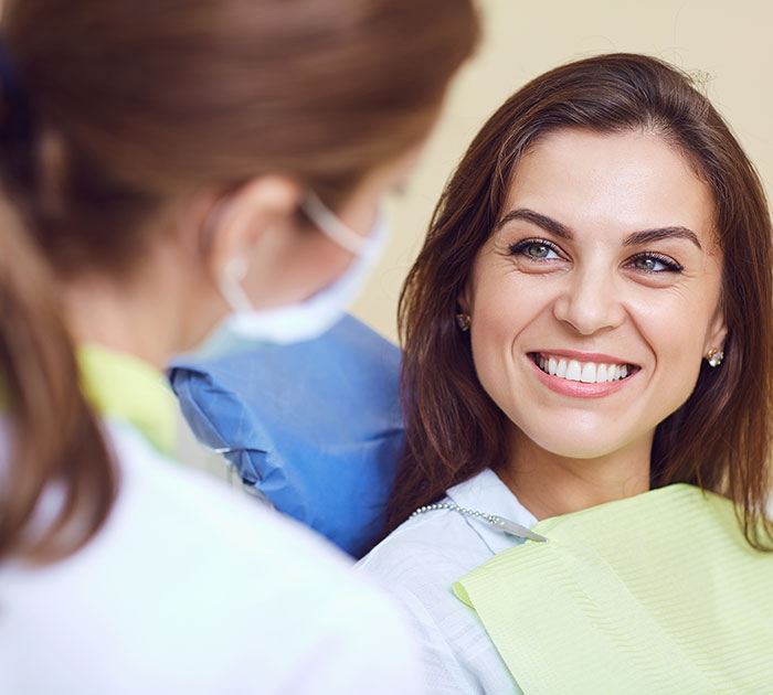 Smiling woman talking with her dentist during a dental check-up